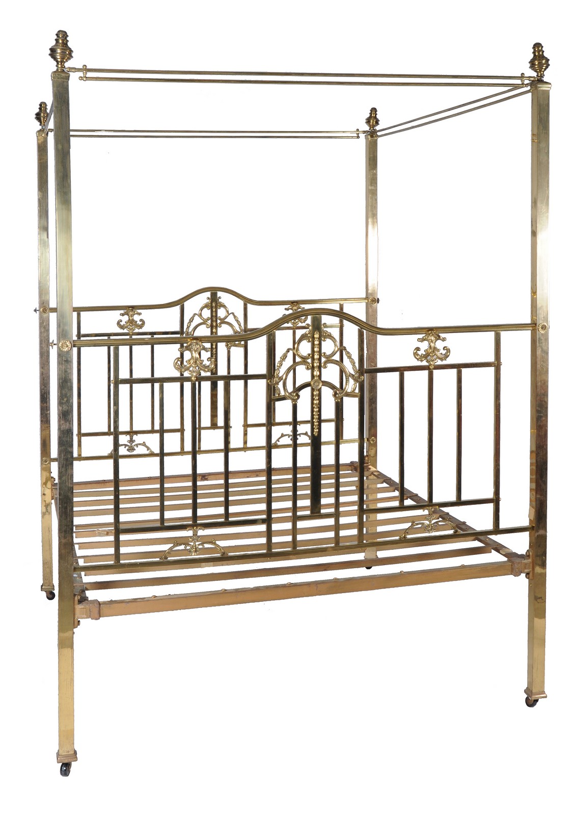 A brass four poster bed in Victorian style, 20th century, the ring finials above canopy rails and