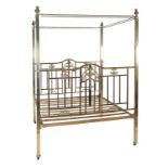 A brass four poster bed in Victorian style, 20th century, the ring finials above canopy rails and