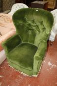 An early 20th century green velour armchair. Best Bid