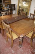 A Victoria mahogany wind out extending dining table with two extra leaves raised on turned