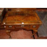 An 18th Century walnut lowboy with a crossbanded top, three frieze drawers on cabriole legs