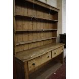 An old pine dresser, enclosed plate rack, two drawers and an enclosed potboard below.228cm high x