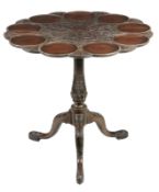 A George III style mahogany tripod table, circa 1780, the scalloped edge top with a central