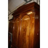 A mid 19th century mahogany wardrobe, arch panelled doors, with a drawer below.233cm high x 146cm