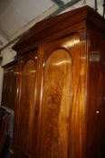 A mid 19th century mahogany wardrobe, arch panelled doors, with a drawer below.233cm high x 146cm