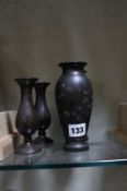 A pair of Japanese bronze vases, relief decorated, inverse baluster shaped, 15cm high and a pair