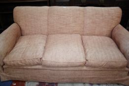 A three seat sofa with feather and down filled cushions in pink drill upholstery. 196cm wide x