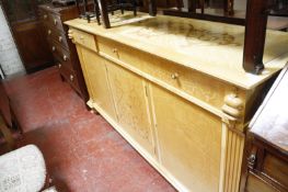 A Linley design sideboard with three frieze drawers flanked by seabeast masks, above cupboards