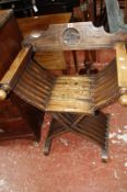 An Italian 19th century walnut Savonarola X-frame chair with mysterious symbol of a hand holding a