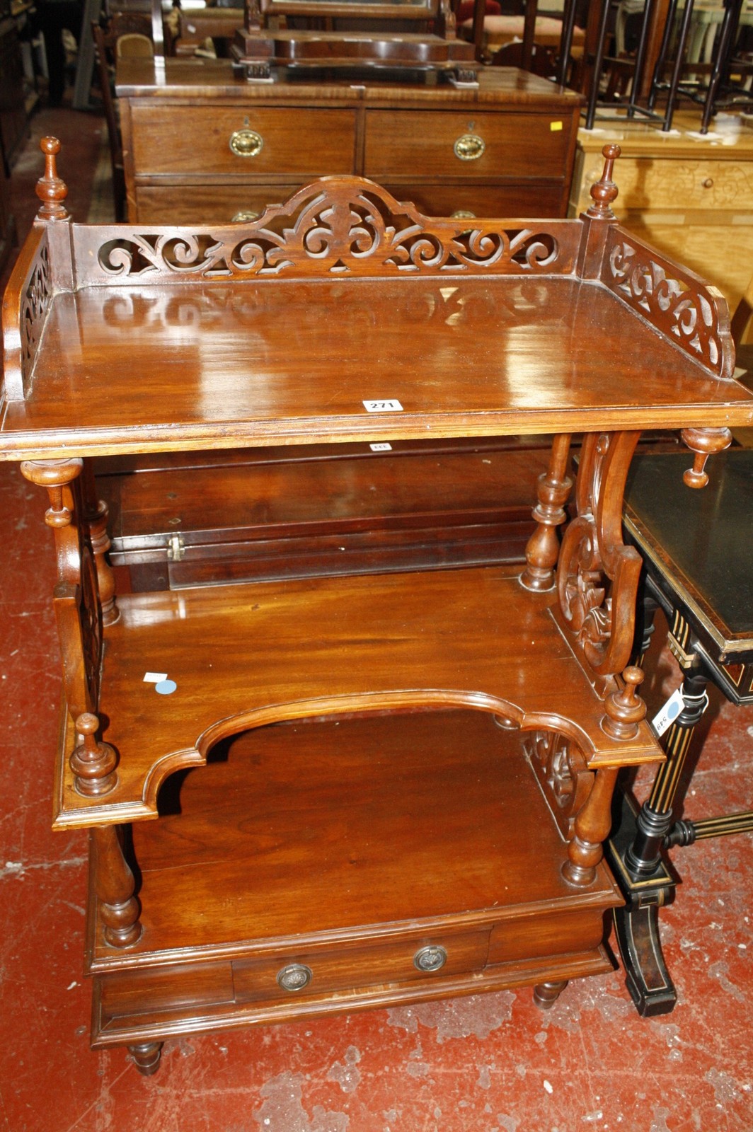 A Victorian mahogany three tier whatnot with scroll and column supports 119cm high, 72cm wide