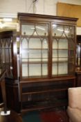 A 19th Century library bookcase with Gothic glazed upper section over open shelves below.140cm