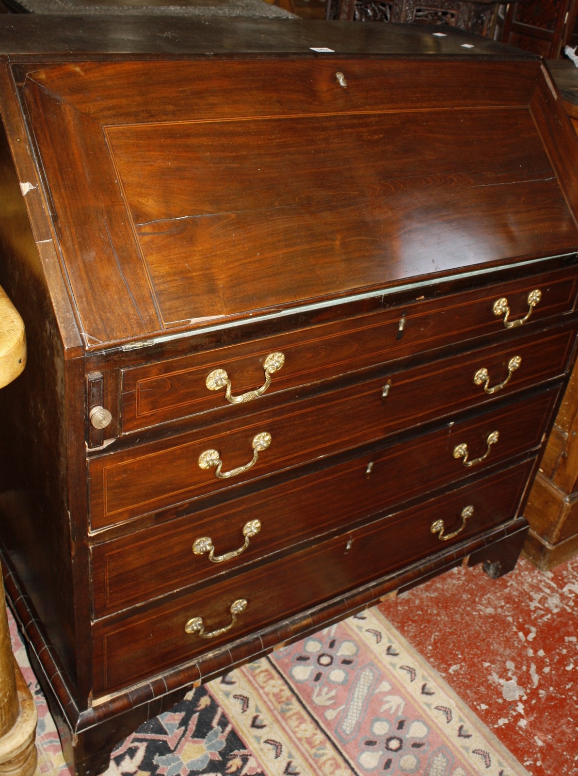 A George III mahogany bureau with four long graduated drawers 98cm wide Best Bid