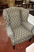 A George III style wing armchair, on square supports.