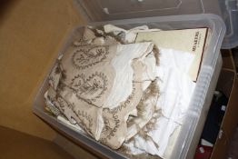 A box of household linens, to include baby clothes, a net veil and a woven shawl