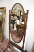 An Edwardian oval cheval mirror. 168cm high.