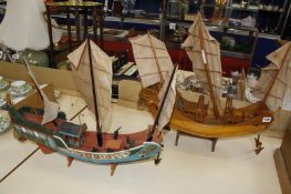 Two scale model wooden junks, one with hand painted decoration, both 57cm long approx.
