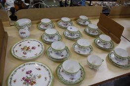 A porcelain part tea set decorated with a green rim and floral sprays (approximately 35 items). Best