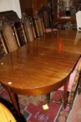 A 19th Century D end dining table with a fold out center section. Best Bid