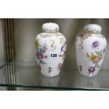 A pair of Dresden oviform vases and covers, decorated with flowers, 18cm high