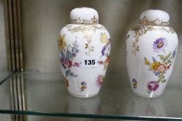 A pair of Dresden oviform vases and covers, decorated with flowers, 18cm high