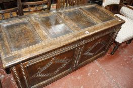 A 19th Century oak coffer with a panelled hinged top and diamond carved front.128cm wide x 54cm deep
