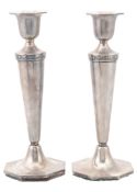 A pair of silver candlesticks by Walker & Hall, Sheffield 1925  A pair of silver candlesticks by