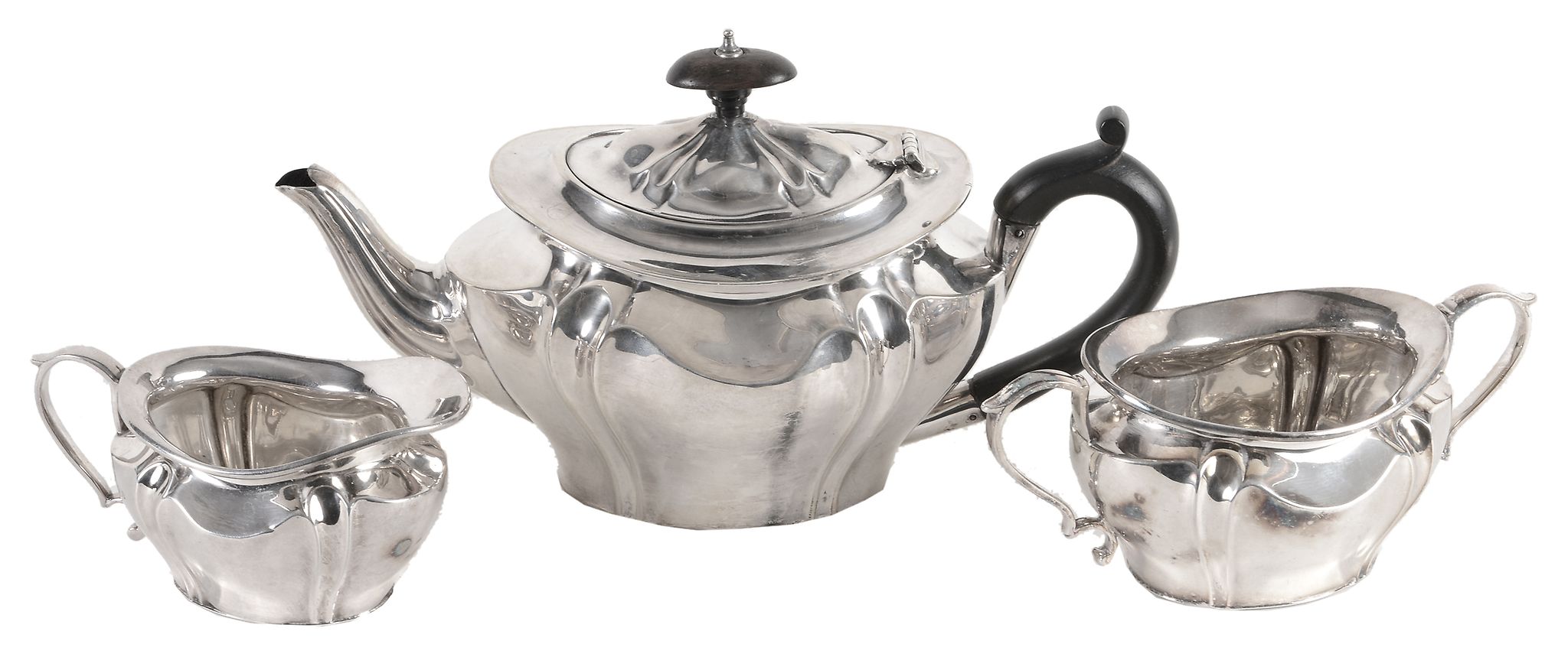 An Edwardian silver shaped oval baluster and wrythen three piece tea service...  An Edwardian silver