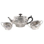 An Edwardian silver shaped oval baluster and wrythen three piece tea service...  An Edwardian silver