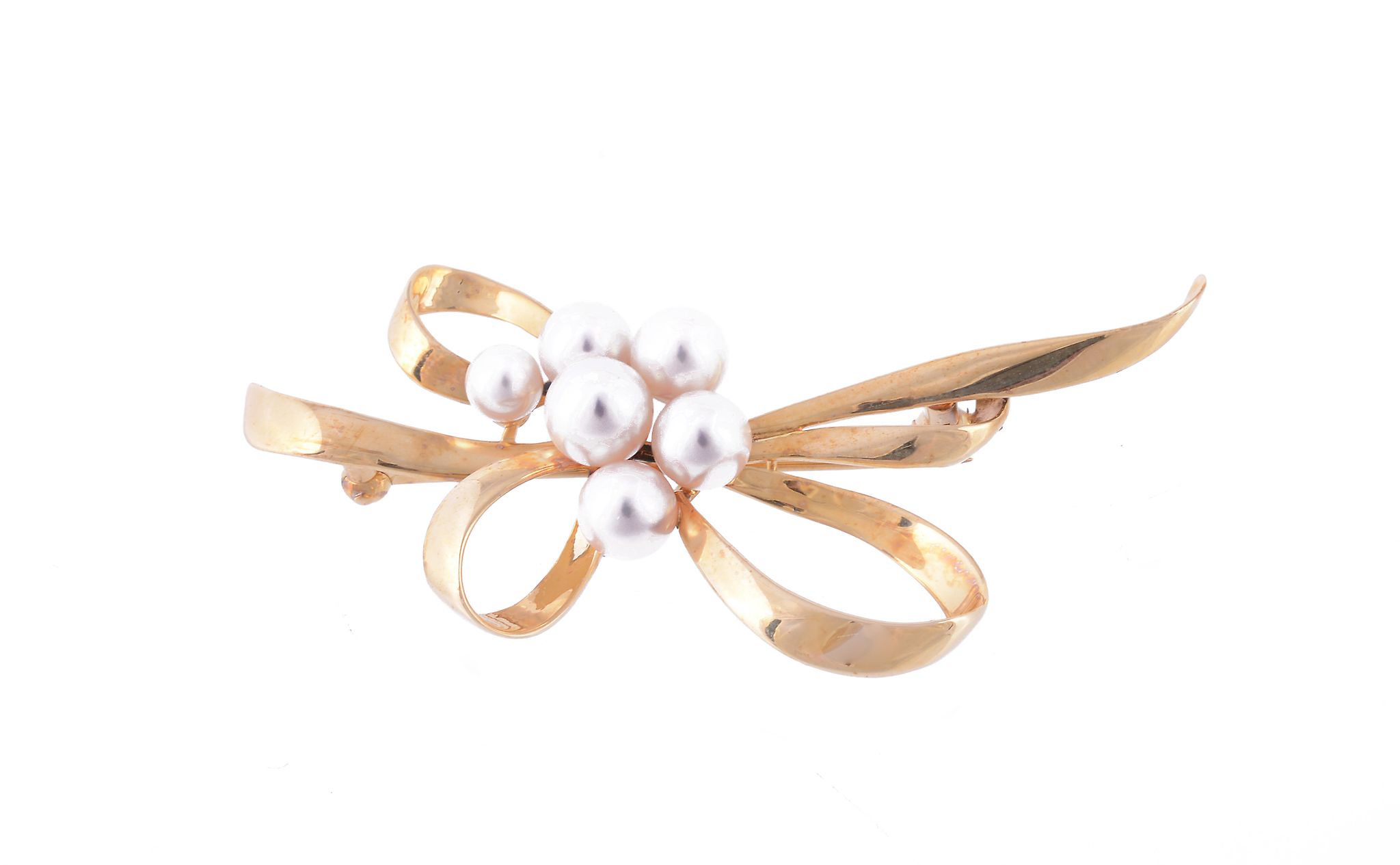A Mikimoto cultured pearl brooch, the abstract bow with a partial cluster, stamped with the