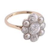 An Edwardian diamond and pearl cluster ring, circa 1910, the central old brilliant cut diamond in a