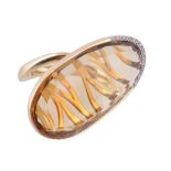 A citrine ring, the flattened oval shaped citrine, with diamond accents to the base of the setting,