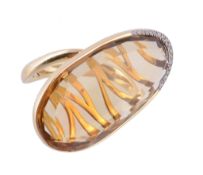 A citrine ring, the flattened oval shaped citrine, with diamond accents to the base of the setting,