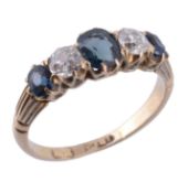 A late Victorian sapphire and diamond ring, circa 1900, the central oval shaped sapphire claw set