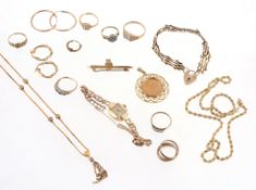 A collection of gold coloured jewellery , to include: a sovereign set pendant; a gold coloured