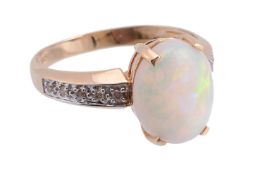 An opal and diamond ring, the central oval cabochon opal in four claw setting, with brilliant cut
