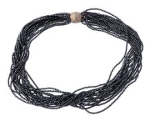 A hematite torsade necklace, the multiple strand necklace of uniform hematite beads, to a diamond