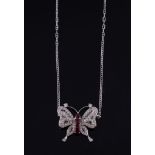 A ruby and diamond butterfly pendant, the body set with oval shaped rubies with a circular shaped