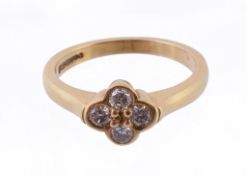 A four stone diamond dress ring, the brilliant cut diamonds set as a quatrefoil, stamped 750,