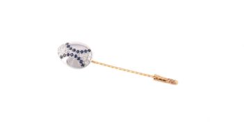 An 18 carat gold diamond and sapphire stick pin by Theo Faberge, the egg shaped panel set with