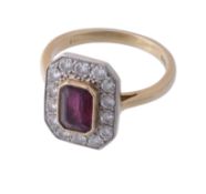 An 18 carat gold ruby and diamond ring, the central rectangular cut cornered ruby in a cut down