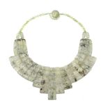 A rutilated quartz necklace, the polished graduated undulating panels to a polished bead necklace,