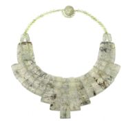 A rutilated quartz necklace, the polished graduated undulating panels to a polished bead necklace,