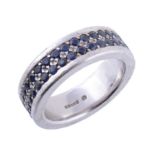 A sapphire set eternity ring by Theo Fennell , the white gold band set with two rows of round cut