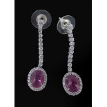 A pair of 18 carat gold ruby and diamond ear pendents, the oval cabochon ruby claw set within a