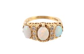An 18 carat gold opal and diamond ring, the three oval shaped opals claw set with brilliant cut
