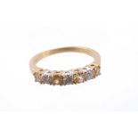 A diamond and colour treated yellow diamond half eternity ring, the six brilliant cut diamonds set