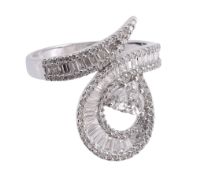 A diamond dress ring, of twisting design set throughout with brilliant cut, baguette cut, pear cut