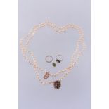 A cultured pearl necklace, the two strand necklace composed of uniform cultured pearls, on a