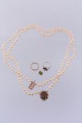 A cultured pearl necklace, the two strand necklace composed of uniform cultured pearls, on a