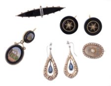 A pair of jet earrings, the circular panels of jet set with a central seed pearl in a six pointed